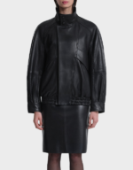 Women's oversized black lambskin bomber jacket on a model, front view, zipped with the tall two-snap collar standing