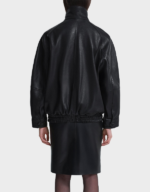 Back view of the women's oversized black lambskin bomber jacket, showing raglan seams, the elastic hem and snap cuffs