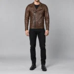 Standing front view of a men's brown leather biker jacket with chest zipper pocket, side zipper pockets and snap flap