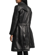 Back view of the women's black leather trench coat, showing the quilted yoke and sleeves and the belt across the waist