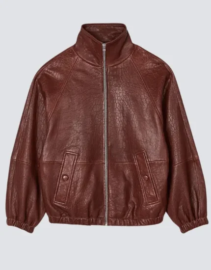 Women's oversized brick red leather bomber jacket laid flat, front view, with a stand collar, center zip and snapped flap pockets